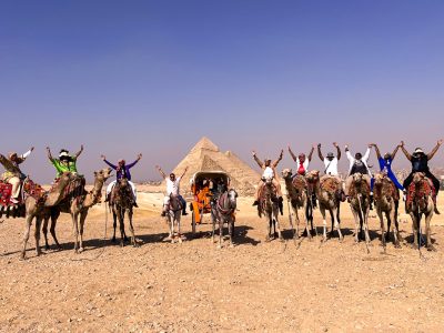 A wonderful picture of some of our visitors in front of the pyramids while riding camels
