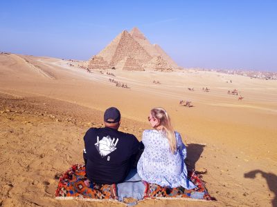 Wonderful pictures of a couple sitting in front of the pyramids