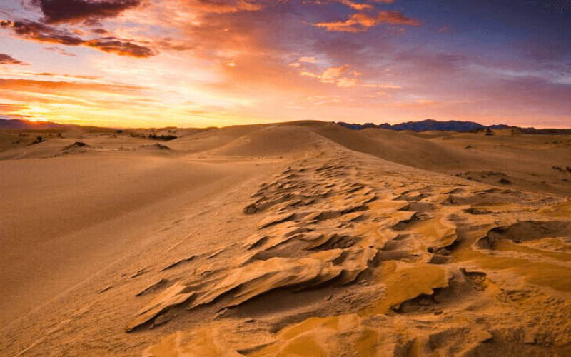 the breathtaking view of the sunrise over the desert dunes landscape of desert egypt