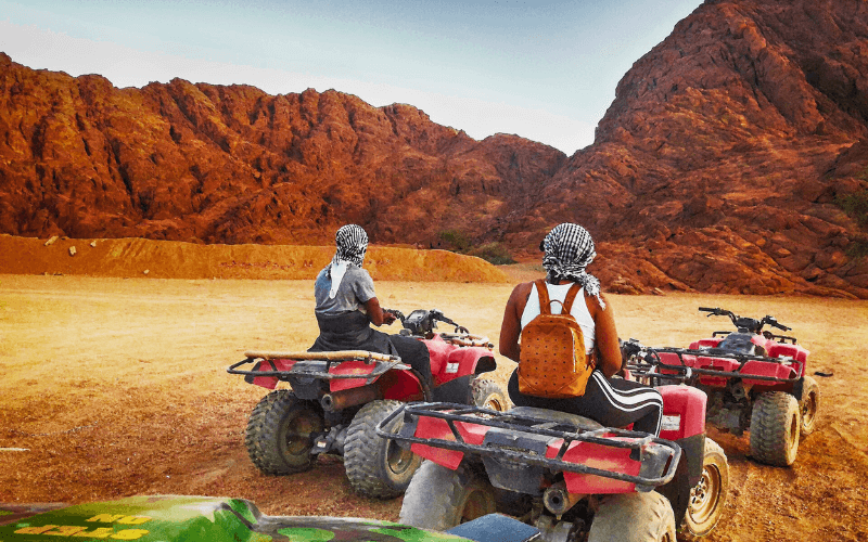 travelers enjoy an exhilarating quad bike adventure during their desert safari in egypt