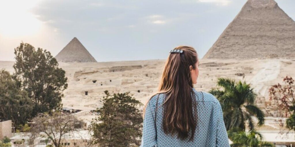 a fantastic woman is in awe of the magnificence of the pyramids of giza